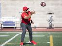Then-Alouettes coach Khari Jones catches a ball prior to a pre-season game against the Ottawa Redblacks in 2022.