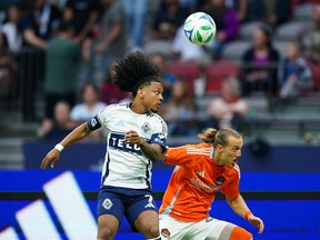 VANCOUVER, BRITISH COLUMBIA - AUGUST 17: Jayden Nelson #7 of the Vancouver Whitecaps FC battles for the ball against Griffin Dorsey #25 of the Houston Dynamo FC during the MLS match between Vancouver Whitecaps FC and Houston Dynamo FC at BC Place on August 17, 2025 in Vancouver, British Columbia.