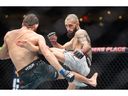 Charles Jourdain, right, kicks Victor Henry during a bantamweight bout at UFC Fight Night in Edmonton on Saturday, November 2, 2024.