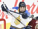 Then-Toronto Sceptres' Sarah Nurse (20) and Montreal Victoire's Amanda Boulier (44) challenge for the puck during second period PWHL hockey action in Laval, Que., Thursday, January 30, 2025.