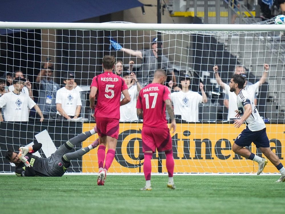Vancouver Whitecaps Brian White, right, celebrates his penalty kick goal against St. Louis City goalkeeper Roman Burki during the game in Vancouver Aug. 23, 2025.