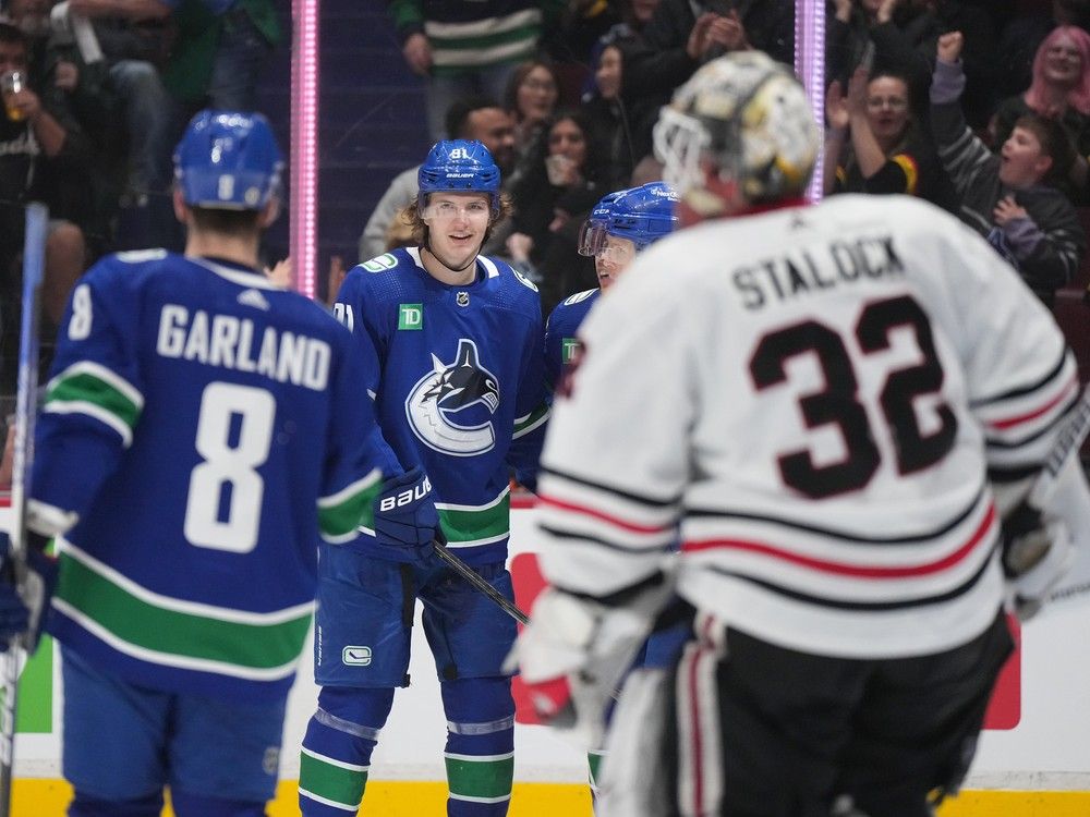 Vancouver Canucks' Vitali Kravtsov (91) celebrates his goal against Chicago Blackhawks goalie Alex Stalock (32) in April 2023