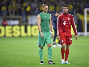 Bayern goalkeeper Manuel Neuer, left, and Bayern's Thomas Muller react after the German Supercup final soccer match between Borussia Dortmund and Bayern Munich in Dortmund, Germany, Saturday, Aug. 3, 2019.