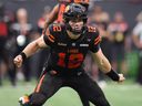 B.C. Lions quarterback Nathan Rourke watches the play after handing off to James Butler during a CFL game against the Montreal Alouettes in Vancouver on Aug. 16.