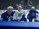 Vancouver Canucks players, including Braeden Cootes (80), listen to instructions for a drill during the opening day of the NHL hockey team's training camp in Penticton on Thursday, September 18, 2025.