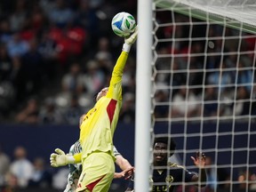 Vancouver Whitecaps' goalkeeper Yohei Takaoka makes a save off a corner kick during the first half of an MLS soccer match against the Portland Timbers, in Vancouver, on Wednesday, September 24, 2025.