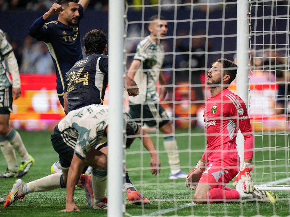 Portland Timbers goalkeeper James Pantemis, right, reacts after allowing a goal to Vancouver Whitecaps' Brian White (24) during the second half of an MLS soccer match, in Vancouver, on Wednesday, September 24, 2025.