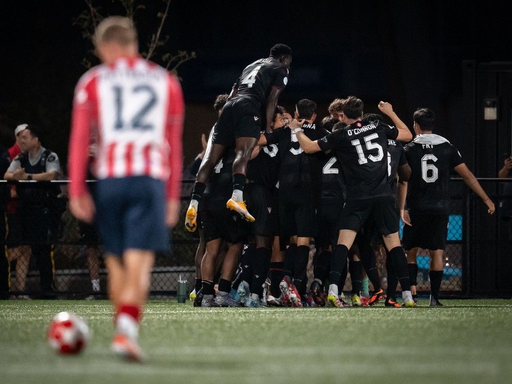 Vancouver FC celebrates Nicolas Mezquida's goal against Ottawa Atletico as Ottawa Atletico's Monty Patterson (12) watches during second half Canadian Championship semifinal soccer action, in Langley, B.C., on Wednesday, August 13, 2025.