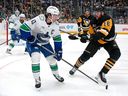 Quinn Hughes is pressured by Penguins forward Justin Brazeau during Wednesday game in Pittsburgh.