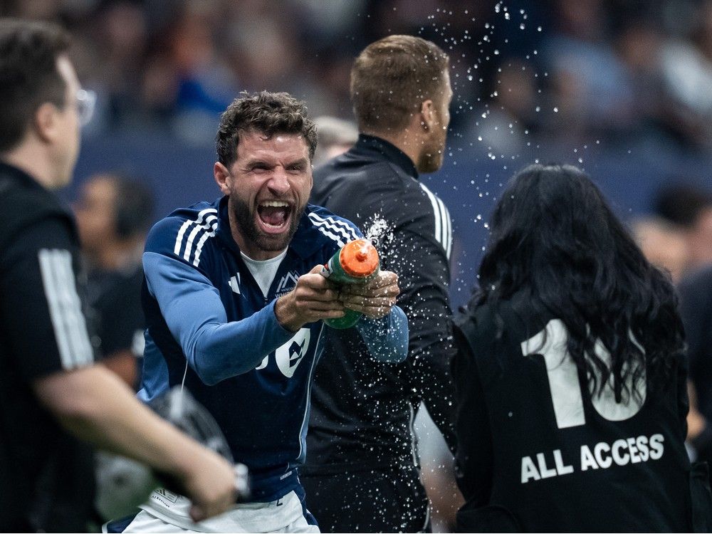 Vancouver Whitecaps' Thomas Muller sprays a camera person after defeating Vancouver FC in the Canadian Championship final soccer match in Vancouver, October 1.