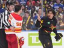 Kiefer Sherwood gestures at Calgary's MacKenzie Weegar after getting into a scuffle during a game in Vancouver on Oct. 9.