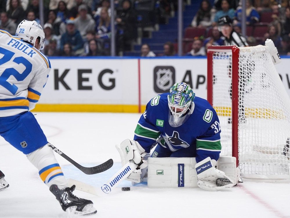 Kevin Lankinen makes a save on pinching Blues' defenceman Justin Faulk on Monday at Rogers Arena.