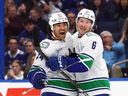 Vancouver Canucks winger Kiefer Sherwood celebrates his game-tying goal against the Tampa Bay Lightning on Nov. 16 in Florida with teammate Brock Boeser.