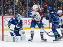 Canucks goalie Kevin Lankinen makes the save as teammate Quinn Hughes and Colorado Avalanche's Ross Colton and Gavin Brindley watch on Sunday, Nov. 9, 2025.