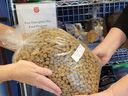 Volunteers hand out pet food at the Nanaimo Salvation Army for clients with dogs or cats.
