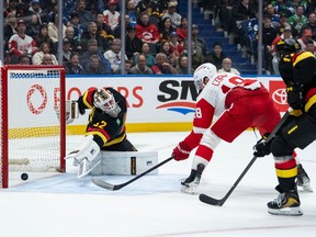 Detroit Red Wings' Andrew Copp (18) scores on Kevin Lankinen (32) as Filip Hronek (17) scrambles back during the second period