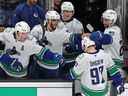 Vancouver Canucks teammates congratulate Liam Ohgren after he scored in a shootout of an NHL game against the Bruins on Dec. 20 in Boston.