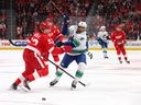 Evander Kane of the Vancouver Canucks tries to get around Moritz Seider of the Detroit Red Wings during a game last month in Detroit.