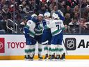 Brock Boeser celebrates his goal with teammates on Thursday.