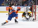 Vancouver Canucks goalie Kevin Lankinen, right, watches the puck as New York Islanders' Maxim Tsyplakov puts a shot off the side of the net during the first period at Rogers Arena on Monday night.