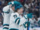 San Jose Sharks' Macklin Celebrini, front, and John Klingberg celebrate Celebrini's goal against the Vancouver Canucks during the first period at Rogers Arena on Tuesday night