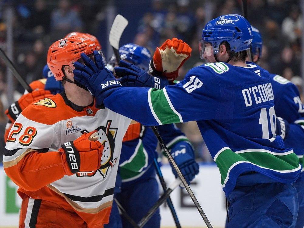 Vancouver Canucks' Drew O'Connor (18) and Anaheim Ducks' Jeffrey Viel (28) get into a scuffle during the first period on Thursday night at Rogers Arena. Vancouver won 2-0.
