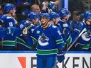 Evander Kane celebrates with teammates on the bench after scoring a goal against the Winnipeg Jets during the second period