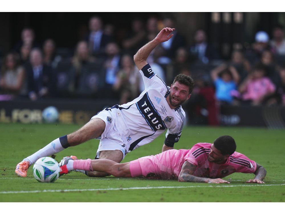 Vancouver Whitecaps' Thomas Muller (top) is taken down by Inter Miami's Rodrigo de Paul (7) during the first half of the MLS Cup final soccer match, in Fort Lauderdale, Fla., on Saturday, December 6, 2025.