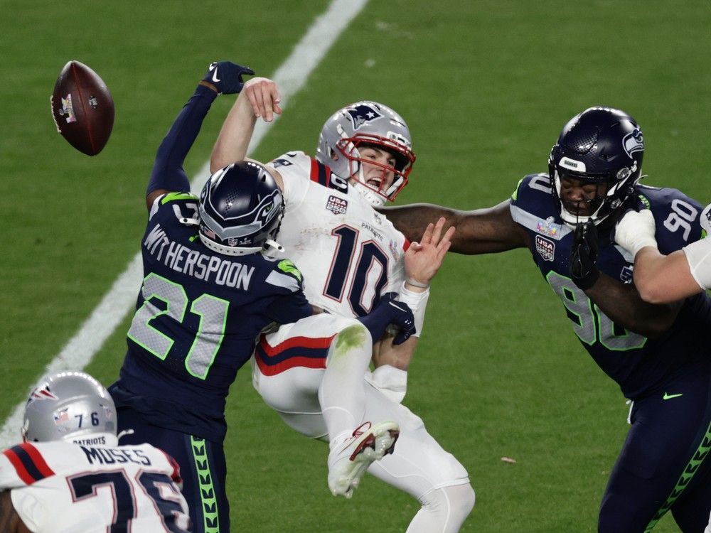 Seattle Seahawks cornerback Devon Witherspoon (21) forces a fumble against New England Patriots quarterback Drake Maye (10) at the NFL Super Bowl 60 game in Santa Clara, Calif., Sunday, February 8, 2026.