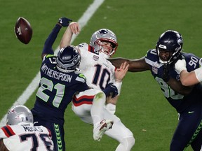 Seattle Seahawks cornerback Devon Witherspoon (21) forces a fumble against New England Patriots quarterback Drake Maye (10) at the NFL Super Bowl 60 game in Santa Clara, Calif., Sunday, February 8, 2026.