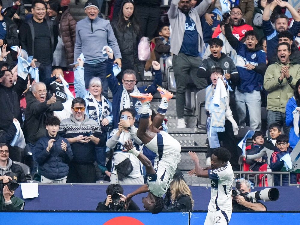 Emmanuel Sabbie of the Vancouver Whitecaps, left, does a flip celebrating a goal with Ali Ahmed in the first half of the Western Conference MLS playoff semifinal against LAFC in Vancouver on Saturday, Nov. 22, 2025. THE CANADIAN PRESS/Darryl Dyck