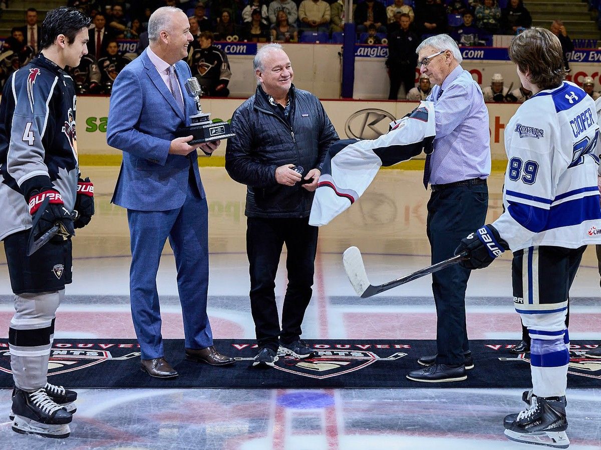 Bill Wilms puts on a Giants jerseys as part of a ceremonial face-off  March 14, 2026, with WHL commissioner Dan Near, Giants majority owner Ron Toigo and minority owner Lewis Buble, and players Giants captain Ryan Lin and Victoria player Miles Cooper.  