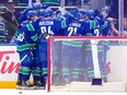 The Vancouver Canucks celebrate after defeating the Los Angeles Kings in overtime during their NHL game at Rogers Arena on April 14.