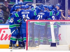 The Vancouver Canucks celebrate after defeating the Los Angeles Kings in overtime during their NHL game at Rogers Arena on April 14.