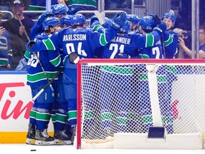 The Vancouver Canucks celebrate after defeating the Los Angeles Kings in overtime during their NHL game at Rogers Arena on April 14.