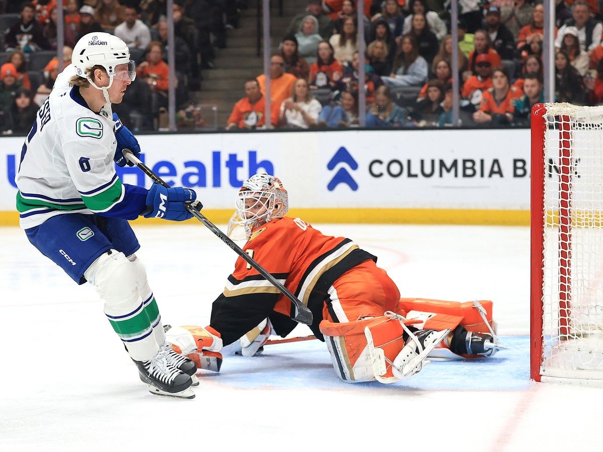 Brock Boeser shoots and scores a goal past Lukas Dostal during the third period