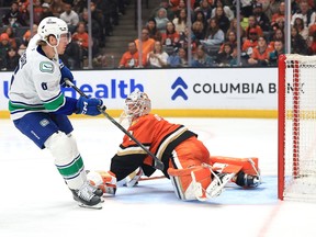 Brock Boeser shoots and scores a goal past Lukas Dostal during the third period