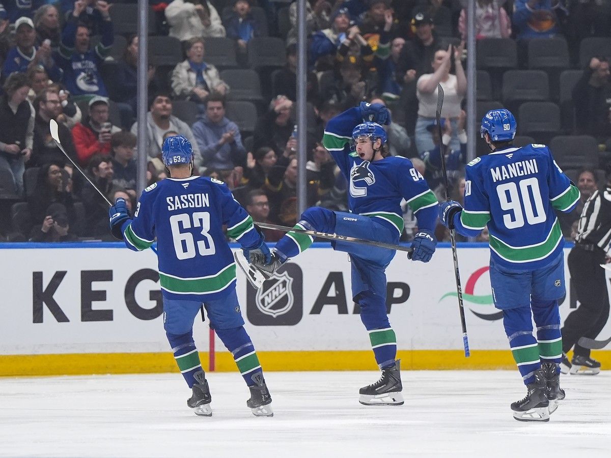 Vancouver Canucks' Linus Karlsson celebrates his second goal of the game with an exuberant kick