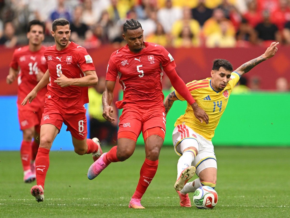 VANCOUVER, CANADA - JULY 07: Manuel Akanji #5 of Switzerland competes for the ball against Gustavo Puerta #14 of Colombia during the FIFA World Cup 2026 Round of 16 match between Switzerland and Colombia at BC Place Vancouver on July 07, 2026 in Vancouver, British Columbia, Canada.