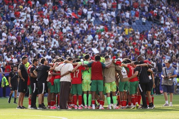 Morocco players and team officials huddle after the 2-0 loss during the FIFA World Cup 2026 Quarter Final match between France and Morocco at Boston Stadium on July 9, 2026 in Foxborough, Massachusetts.