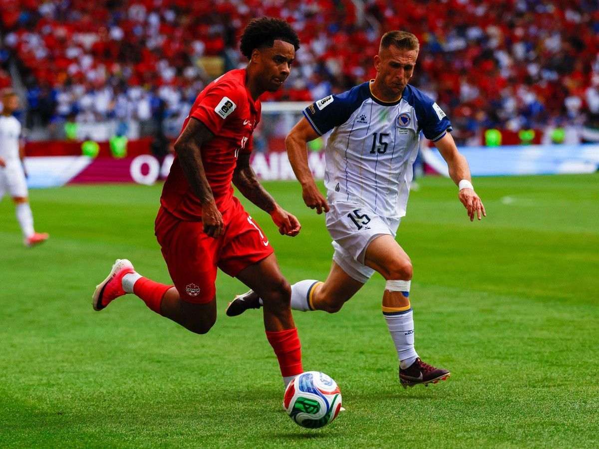 Canada's Tajon Buchanan (17) dribbles the ball against Bosnia and Herzegovina's Amar Memic (15) during the FIFA World Cup 2026 Group B match between Canada and Bosnia and Herzegovina at Toronto Stadium in Toronto on Friday, June 12, 2026.