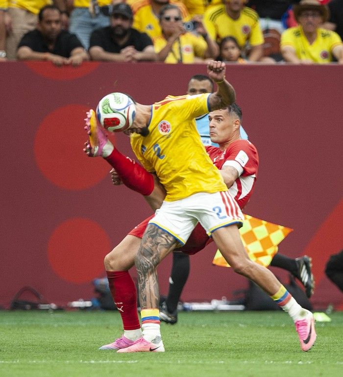Switzerland's Granit Xhaka and Colombia's Daniel Munoz fight for the ball in play between Switzerland and Colombia in Vancouver during the FIFA World Cup 2026 elimination round Tuesday, July 7, 2026.