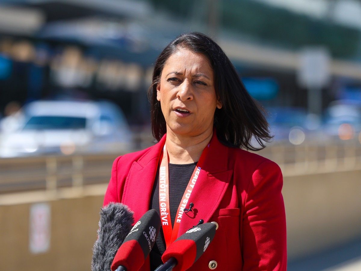 Canadian Union of Public Employees Local 8125 president Alia Hussain speaks with media at the Calgary International Airport on Wednesday, July 15, 2026 after WestJet flight attendants voted 99.4 per cent in favour of a strike.