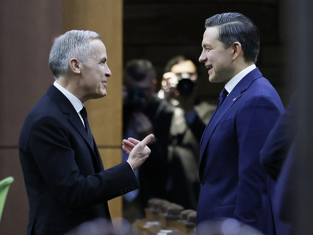 Prime Minister Mark Carney and Conservative Party of Canada leader Pierre Poilievre speak before proceedings in the House of Commons on Parliament Hill in Ottawa February 11, 2026.