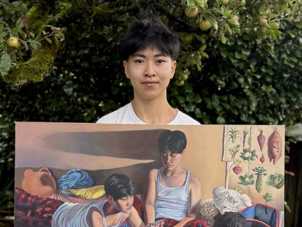 Winston Li, a grade 12 student at Lord Byng Secondary School, stands with his prizewinning painting.
