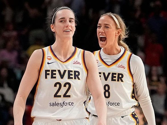 Caitlin Clark #22 of the Indiana Fever celebrates with Sophie Cunningham #8 after scoring the game-winning three pointer during the second half against the Washington Mystics at CareFirst Arena on June 08, 2026 in Washington, DC.