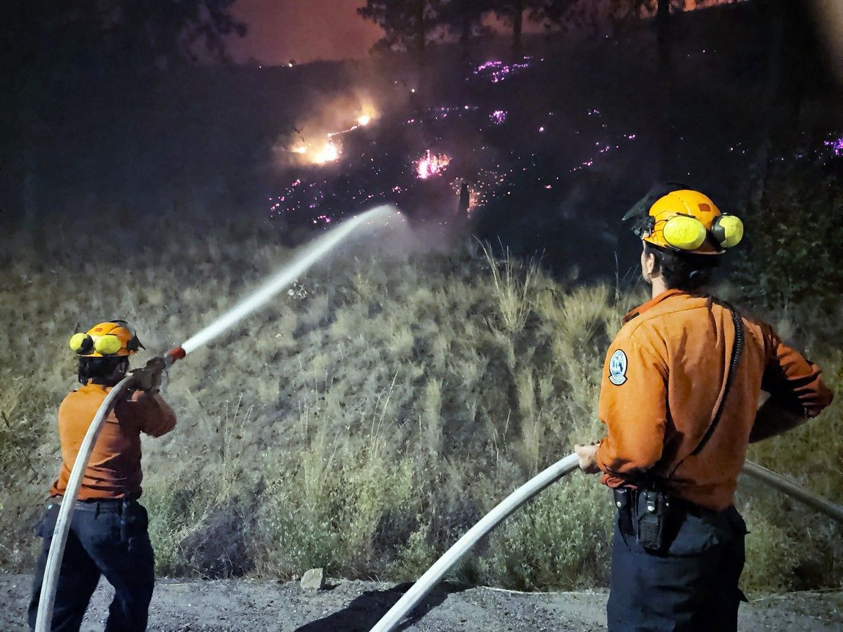 A pair of B.C. Wildfire Service firefighters tackle the Bald Range fire on the night of Aug 7/8, 2026.