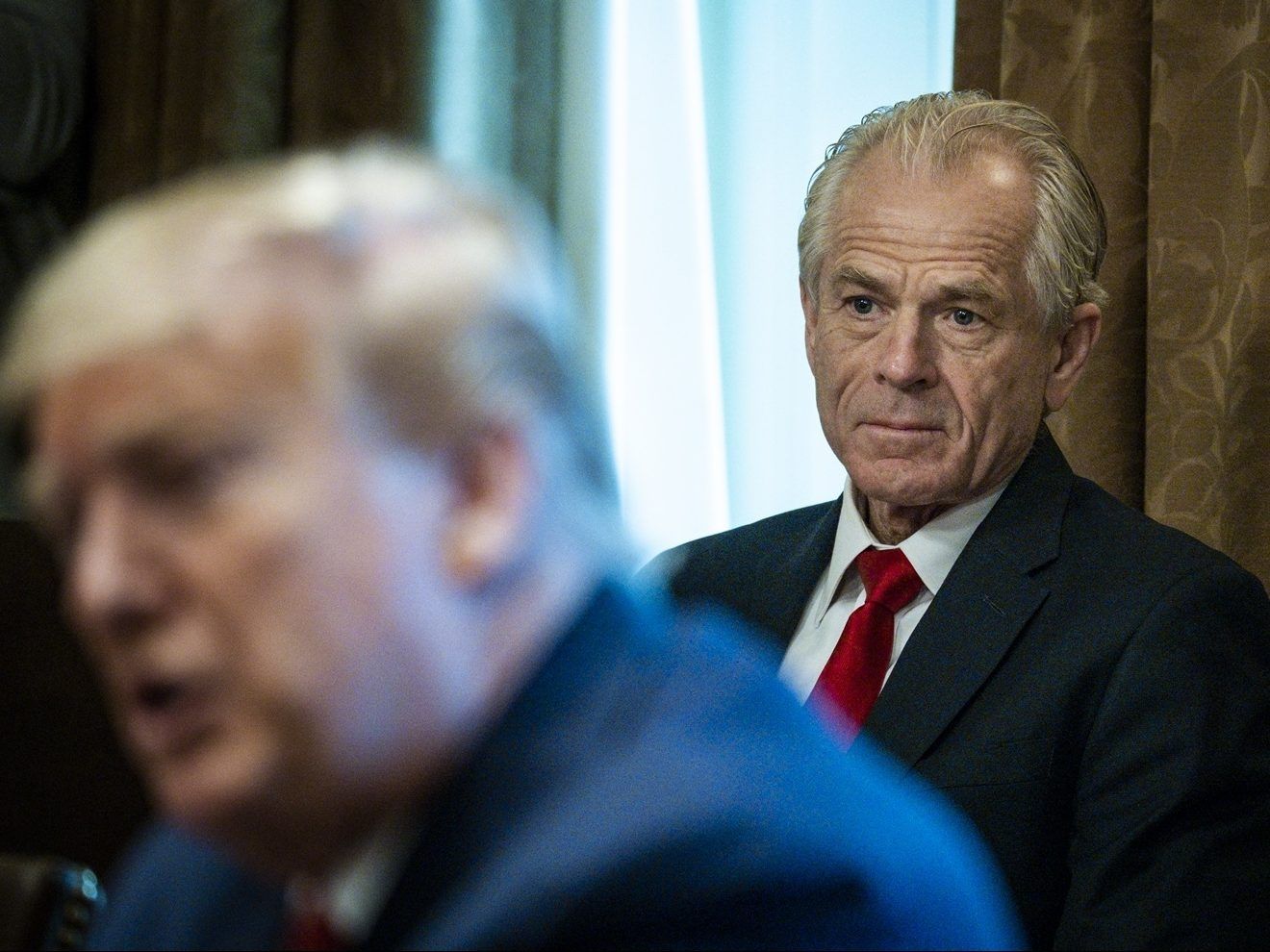 Director of the National Trade Council Peter Navarro looks on as U.S. President Donald Trump meets with supply chain distributors in reference to the COVID-19 coronavirus pandemic in the Cabinet Room in the West Wing at the White House on Sunday, March 29, 2020.