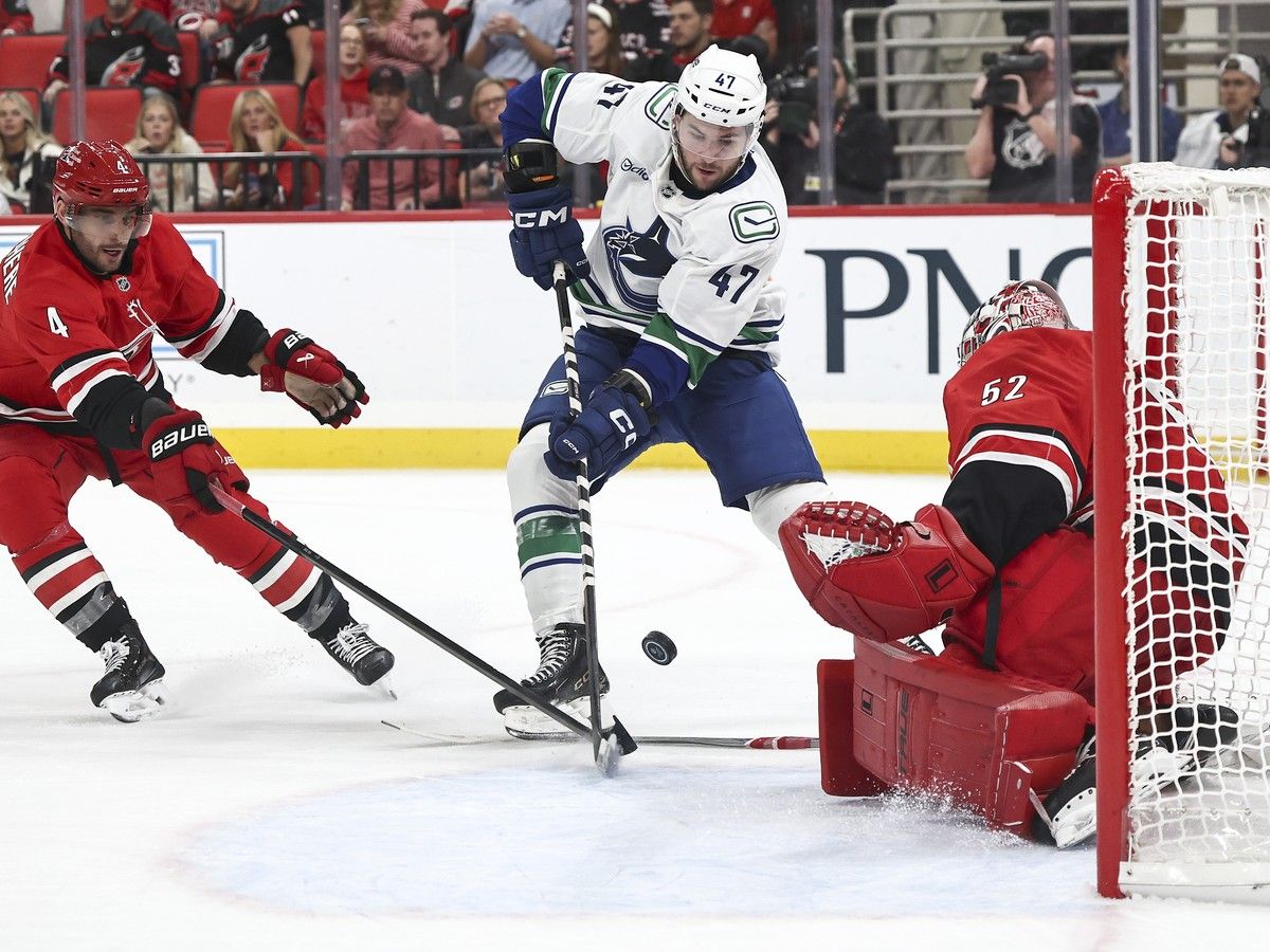 Pyotr Kochetkov of the Carolina Hurricanes saves a shot attempt from Paul Cotter of the Vancouver Canucks during the second period