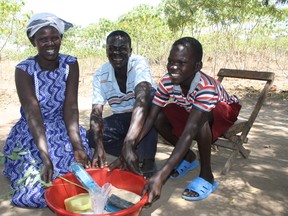 Joel and his parents enjoy gifts of food, soap and a tree.